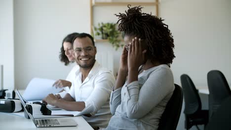 Cheerful-colleagues-talking-and-laughing-during-work
